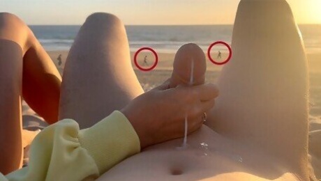 Hand job on a nude beach. We were caught jerking off at sunset near the ocean.